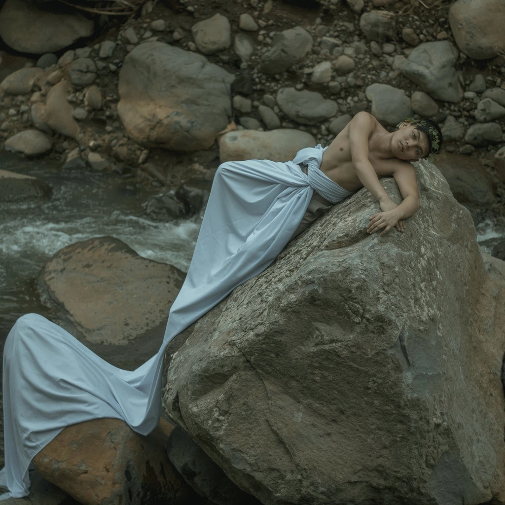 Portrait film still of a young girl cradling a small clay deity figure beside a dying forest fire at dawn